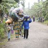 Congolese civilians carry their belongings as they escape recent fighting in Rutshuru.