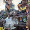 Young girls eat a mid-day meal at a WFP school feeding centre in Guidam Makadam, Niger.