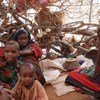 A family in a home-made shelter in Kobe camp, Dollo Ado region of Ethiopia.