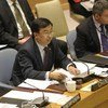 Amb. Li Baodong of China (left), presides over Security Council meeting.