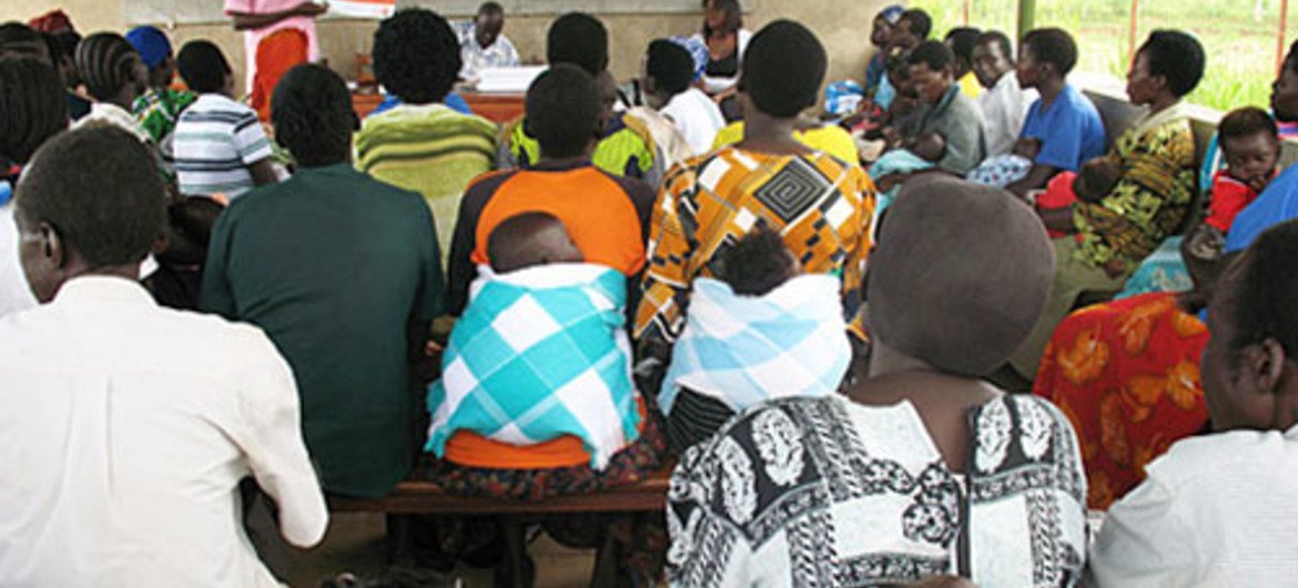 A midwife discusses family planning with men and women.