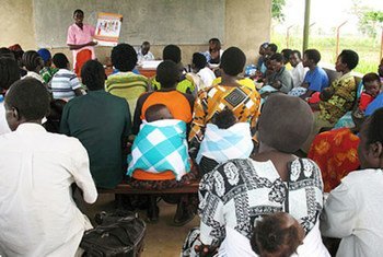 A midwife discusses family planning with men and women.