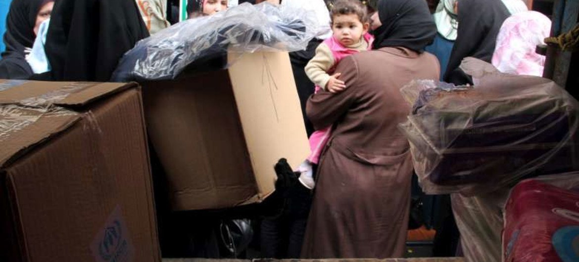 Syrian refugees queue up for UNHCR relief items in Tripoli, northern Lebanon.