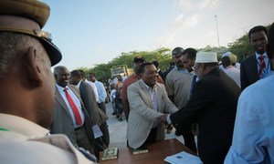 Special Representative Augustine Mahiga greets a Somali official ahead of the inauguration ceremony in Mogadishu.