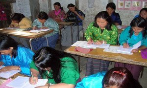 Mothers sit in a class in a Non-formal and Continuing Education programme run by Bhutan’s Department of Adult and Higher Education. The same classroom is used by their children during the day.