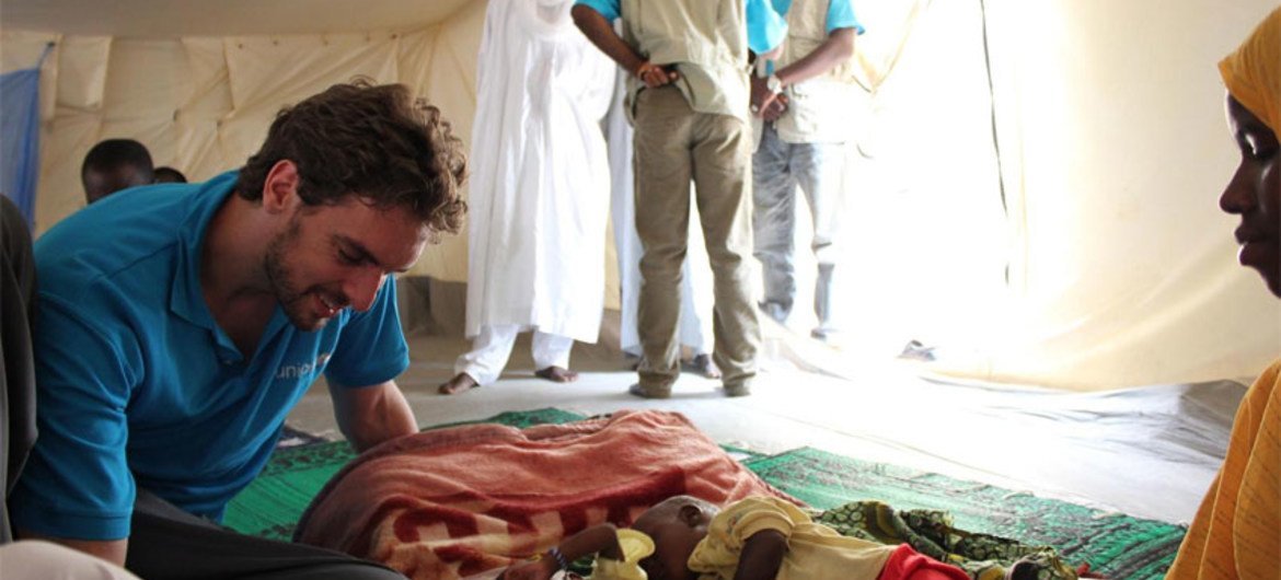 Pau Gasol on visit to Chad is seen here with a mother of twins who is waiting for the full recovery of one of the children.