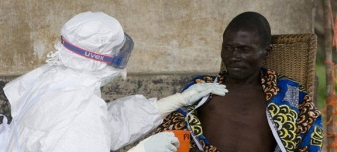 A nurse comforts a patient who has been diagnosed to have the Ebola virus.