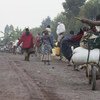 People flee their homes as fighting continued between FARDC and M23 rebels in the Rutshuru territory in July 2012.