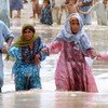 People wade through the flood waters in the district Jaffarabad and Nasirabad, Balochistan.