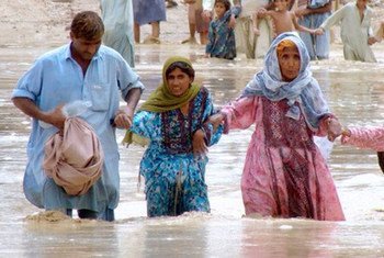 People wade through the flood waters in the district Jaffarabad and Nasirabad, Balochistan.