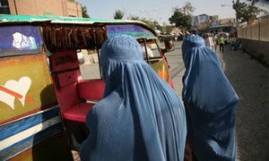 Afghan women bargain with a rickshaw driver in the city of Herat.