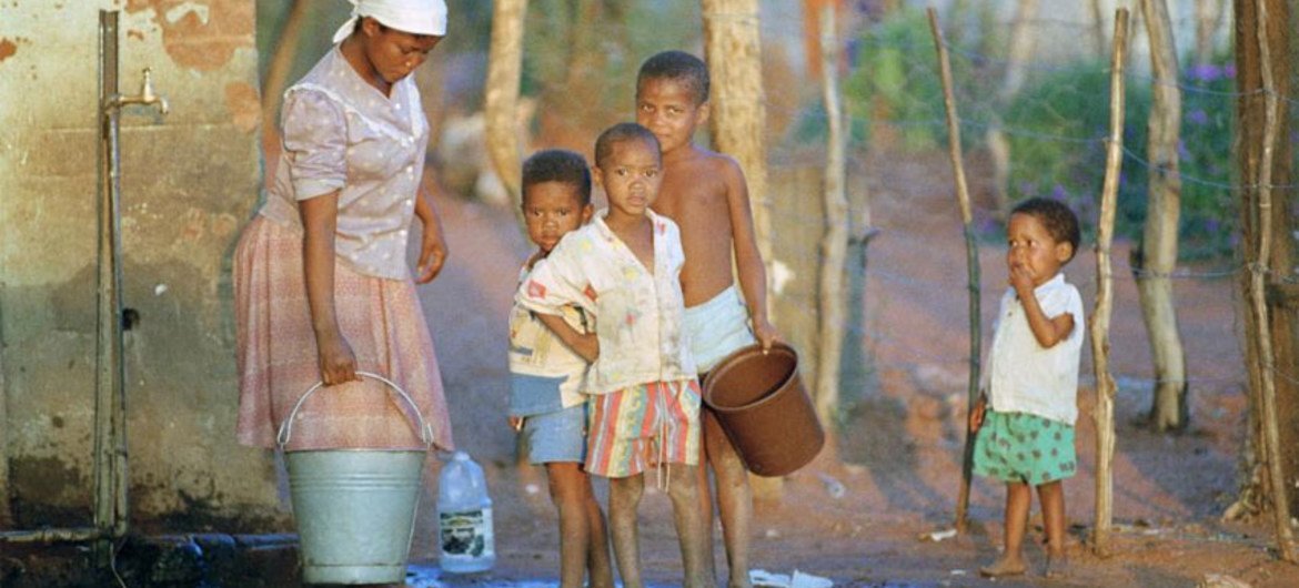 In Namibia a woman collects water for her family’s needs.