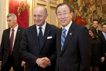 Secretary-General Ban Ki-moon is greeted by French Foreign Minister Laurent Fabius.
