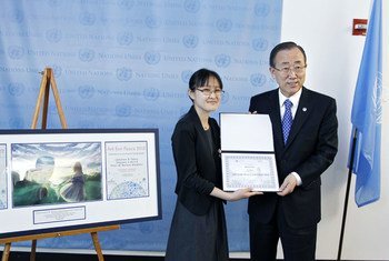 Secretary-General Ban Ki-moon (right) presents an award to Haruka Shoji, winner of the United Nations Art for Peace Contest, organized by the UN Office for Disarmament Affairs.
