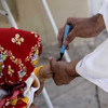 Afghan child being vaccinated against polio in Herat City on 15 October 2012.