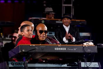 A blind boy named Emmanuel joins American singer and UN Peace Messenger, Stevie Wonder, who is also blind, on stage during the UN Day Concert, “A Message of Peace.”