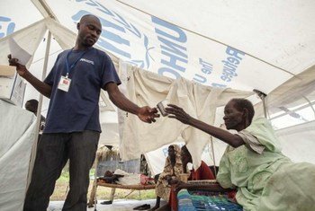 An elderly refugee is given medical care on arrival at a camp in South Sudan.