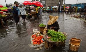 A woman sells produce at a flooded market place in Port-au-Prince after hurricane Sandy ravaged the west of Haiti.