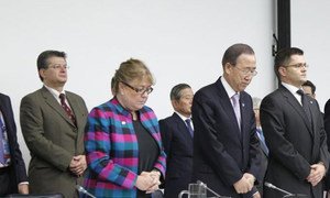 Secretary-General Ban Ki-moon (second right) and General Assembly President Vuk Jeremic (right) observing a moment of silence at the start of a briefing to the Assembly on the impact of Hurricane Sandy.