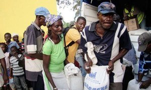 Haitians receive food rations following the passage of Hurricane Sandy.