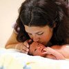 Mother kissing her newborn baby. 15 million babies are born premature every year, or before 37 completed weeks of gestation.