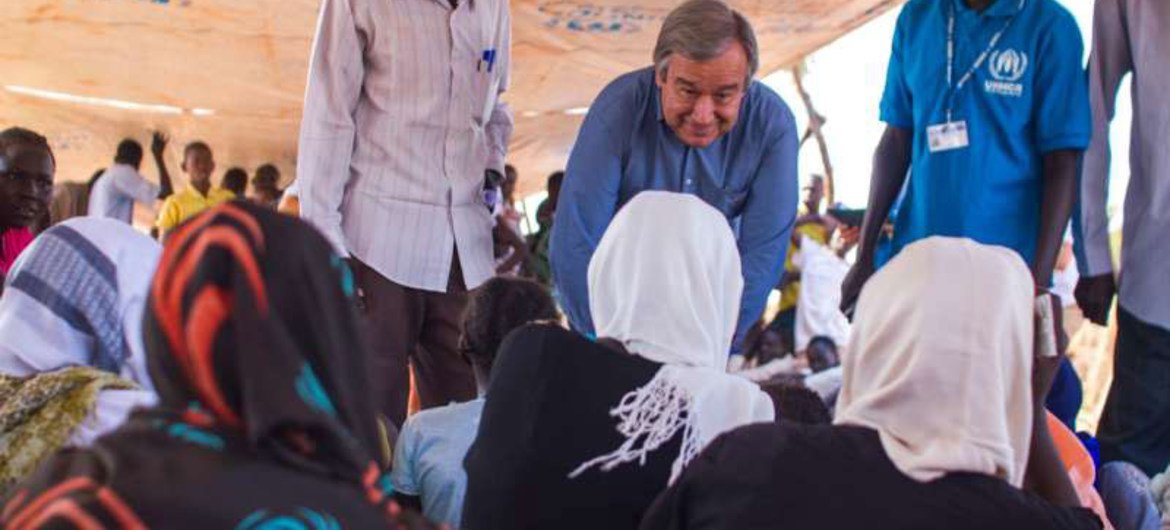 High Commissioner António Guterres (second right) speaks with a group of girls waiting to be registered at Yida settlement in South Sudan.