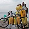 A man loads water collected from Lake Kivu onto his bicycle for sale in Goma, DRC, where municipal supplies have been interrupted.