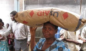 In Malawi, a woman picks up her monthly ration of supercereal.
