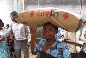 In Malawi, a woman picks up her monthly ration of supercereal.