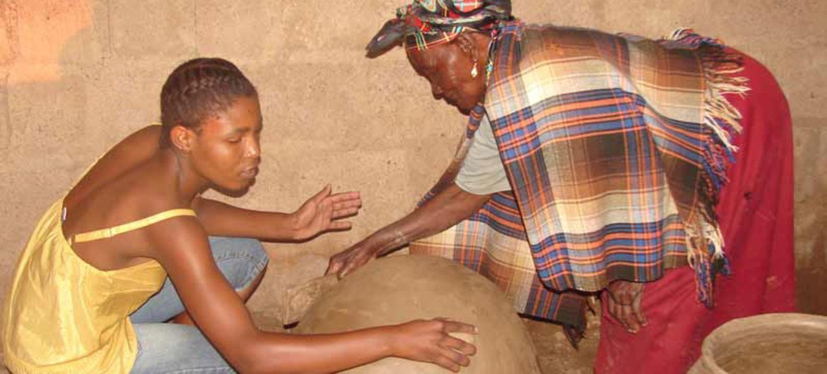 Mmasekgwa Motlhware transmet à sa petite-fille Tumediso le savoir-faire de la poterie en terre cuite dans le district de Kgatleng au Botswana.
