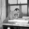 Oscar Niemeyer, one of the original architects of United Nations Headquarters in New York, going over plans for the building on 18 April 1947.