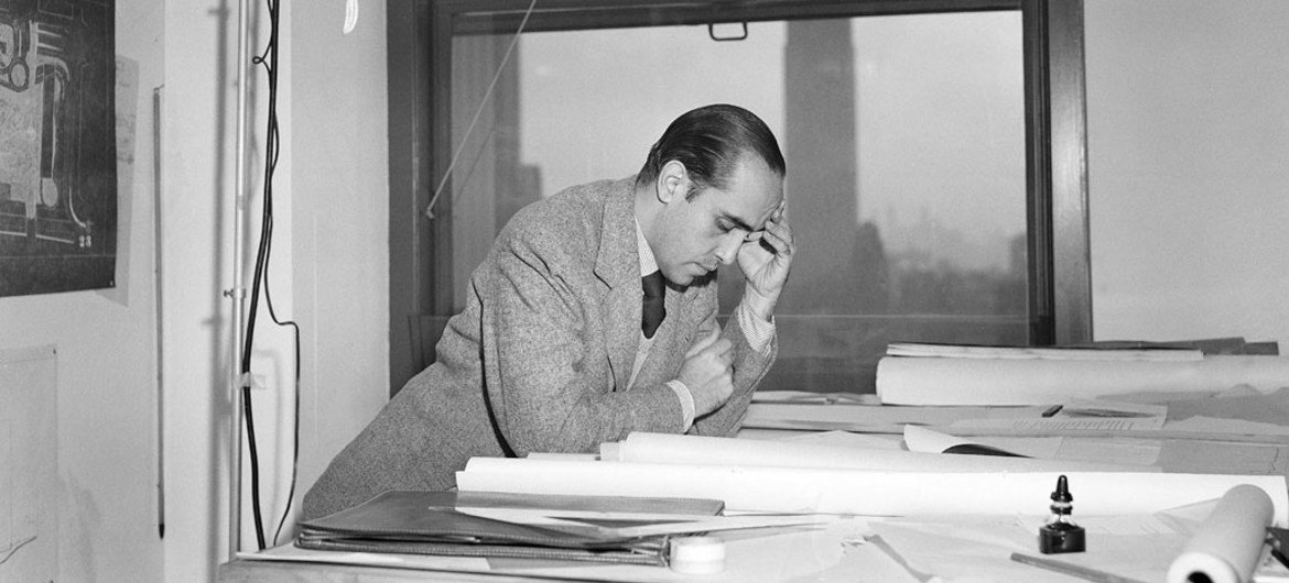 Oscar Niemeyer, one of the original architects of United Nations Headquarters in New York, going over plans for the building on 18 April 1947.