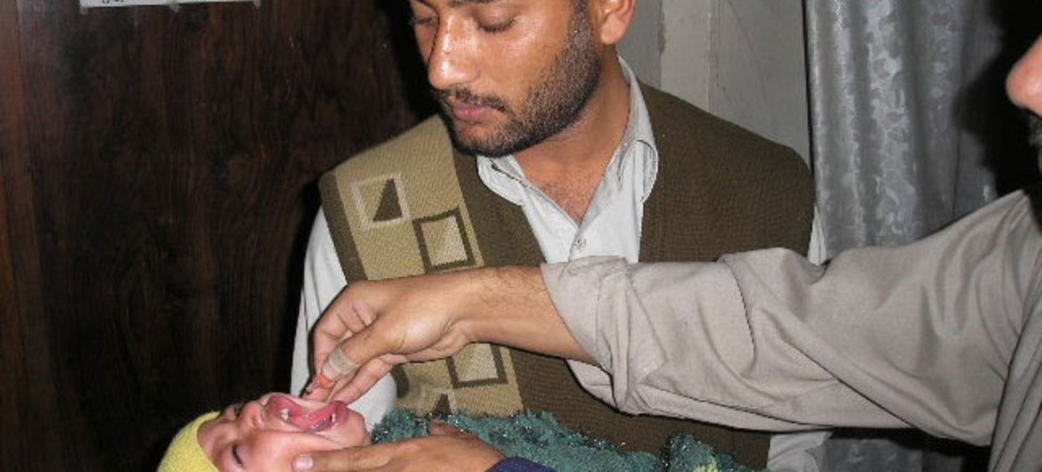 A Pakistani child receives polio drops.