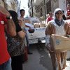 A woman in Damascus, Syria, receives her emergency rations from WFP.