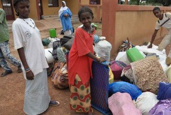 Malian refugees with their belongings after arriving at Goudebou camp in Burkina Faso.