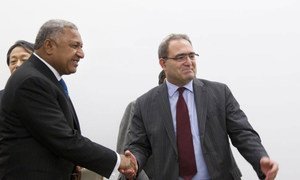 Ambassador Mourad Benmehidi of Algeria (right) hands over the chairmanship of the ‘G-77’ to Commodore Josaia V. Bainimarama, the Prime Minister of Fiji.