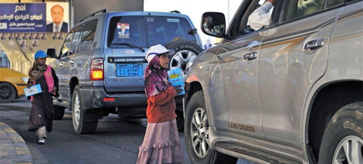 Yasmine Hajiri and her sister sell tissues to passing drivers at an intersection in downtown Sana’a.