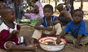 Displaced children in the Mali capital, Bamako, eat a welcome meal.