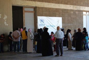 Syrian refugees wait to be registered by UNHCR staff in Lebanon.