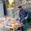 A poor Egyptian selling sweets to earn a living.