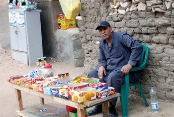 A poor Egyptian selling sweets to earn a living.