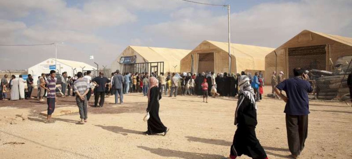 Syrian refugees wait at a UNHCR distribution centre in Za'atari refugee camp in Jordan.