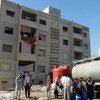Tanker trucks supply water to a housing complex in Adra, an industrial area northeast of Damascus, Syria.