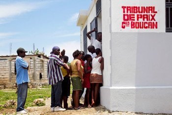 Haitians stand outside the Tribunal de Paix building in the town of Grand Boucan in May 2012.