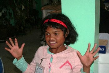 A child learning sign language in Madagascar in preparation for admittance to school.