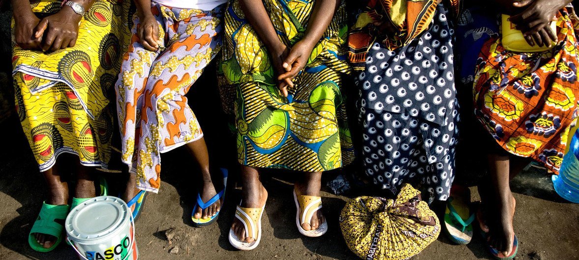 Women sit together outside a dormitory at the Heal Africa Transit Center for victims of sexual violence.