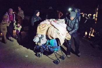 A group of Syrian refugees, making a risky journey by foot from the  governorate of Daá'ra, cross at night into Jordan.