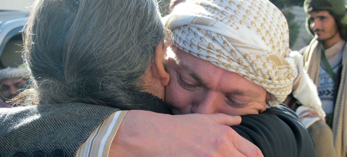 Gert Danielsen (facing camera), a UN staff member with UNDP, embraces a colleague after his release from captivity in Sana’a, Yemen in 2012.