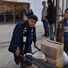 Two Syrian boys collect food for their family from a WFP food distribution centre in the Zaatari refugee camp, Jordan.