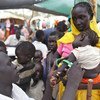 Refugee mothers from Sudan's Blue Nile State wait at a clinic in South Sudan to have their children measured for malnutrition and to vaccinate them against measles.